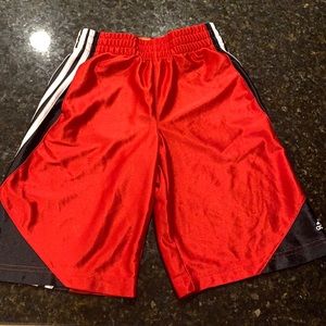 Red basketball shorts by adidas, size Youth S